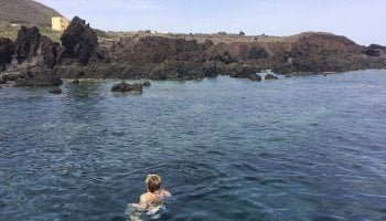 Γυναίκα κολυμπάει στη θάλασσα κοντά σε νησί του συμπλέγματος των Πελαγίων νήσων, στη Σικελία